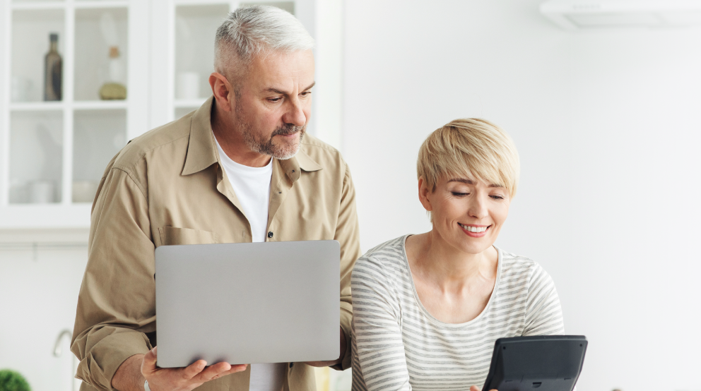 Elderly man with younger man smiling after creating their MyBiron account successfully