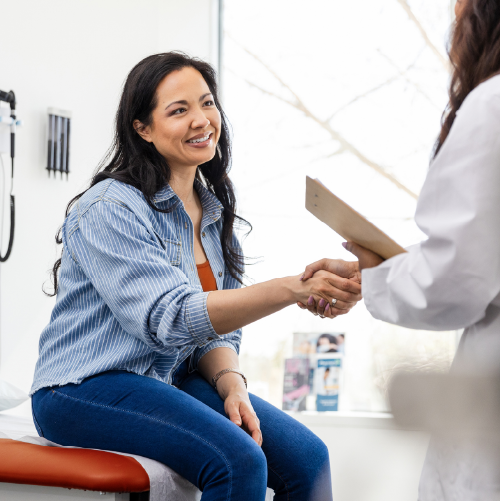Female patient shaking heads with her physician after getting her prescription for a pharmacogenetic test
