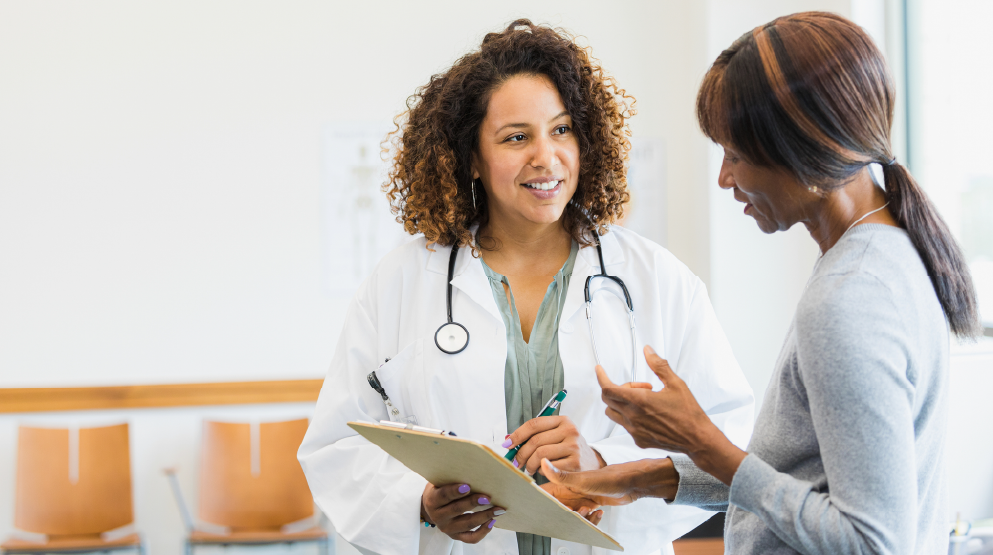 Female doctor talking to a female patient about her new medication adjustment after performing a PGx test
