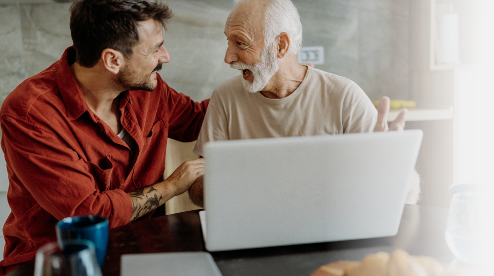 Elderly man with younger man smiling after creating their MyBiron account successfully